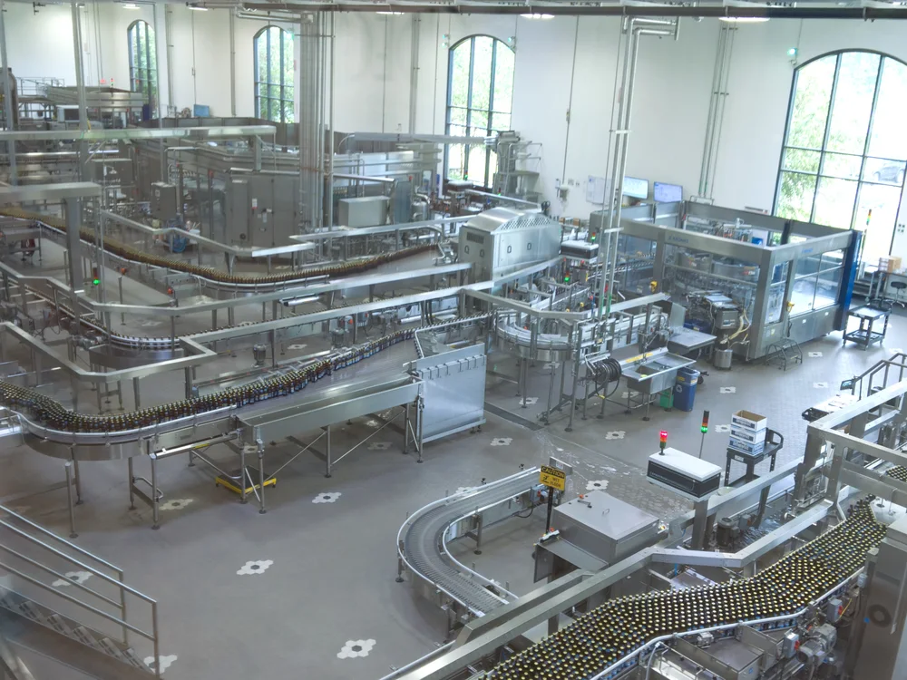 Beverage bottling line with conveyors and processing equipment