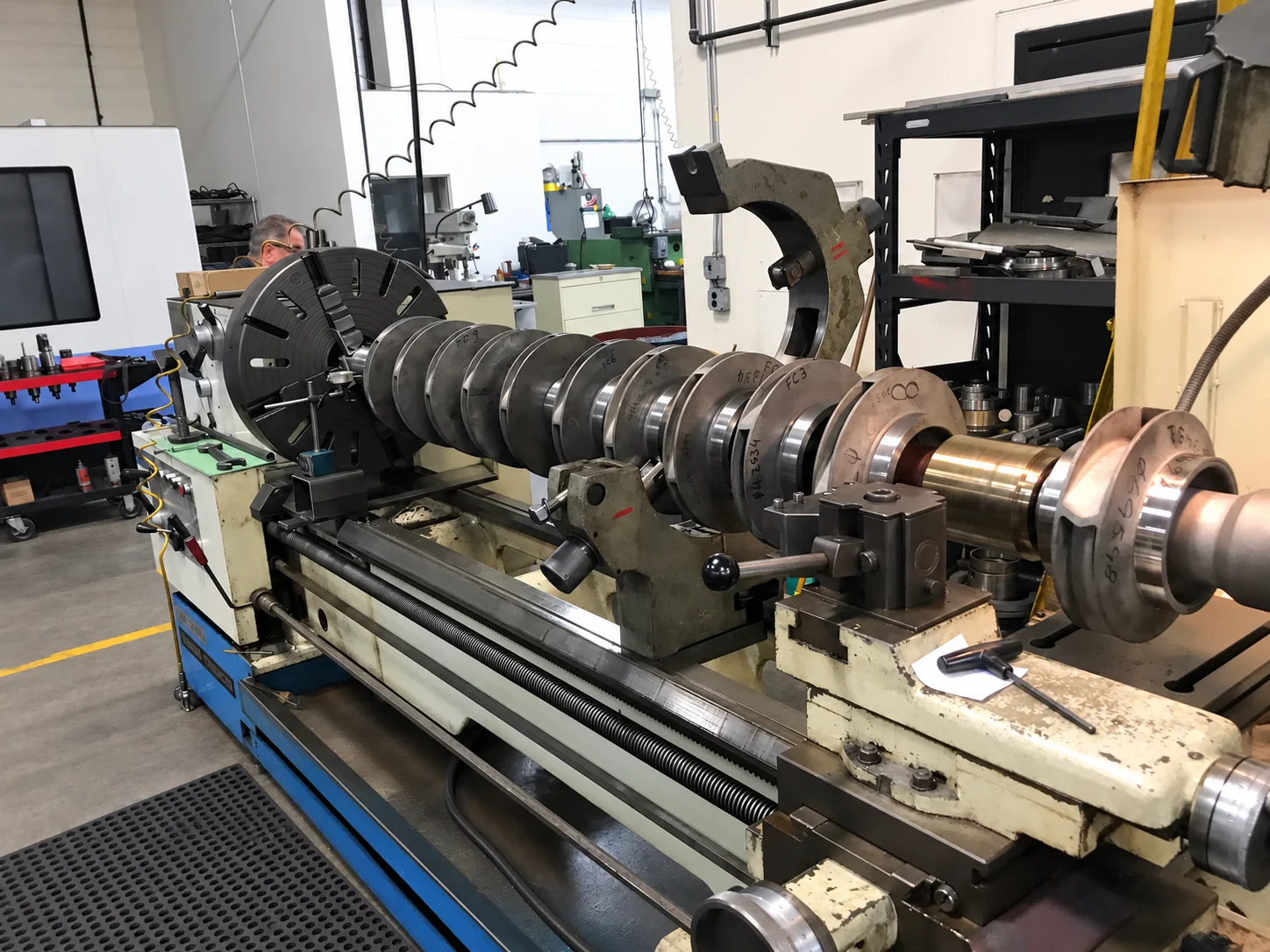 Multi-stage pump rotor mounted in a shop lathe