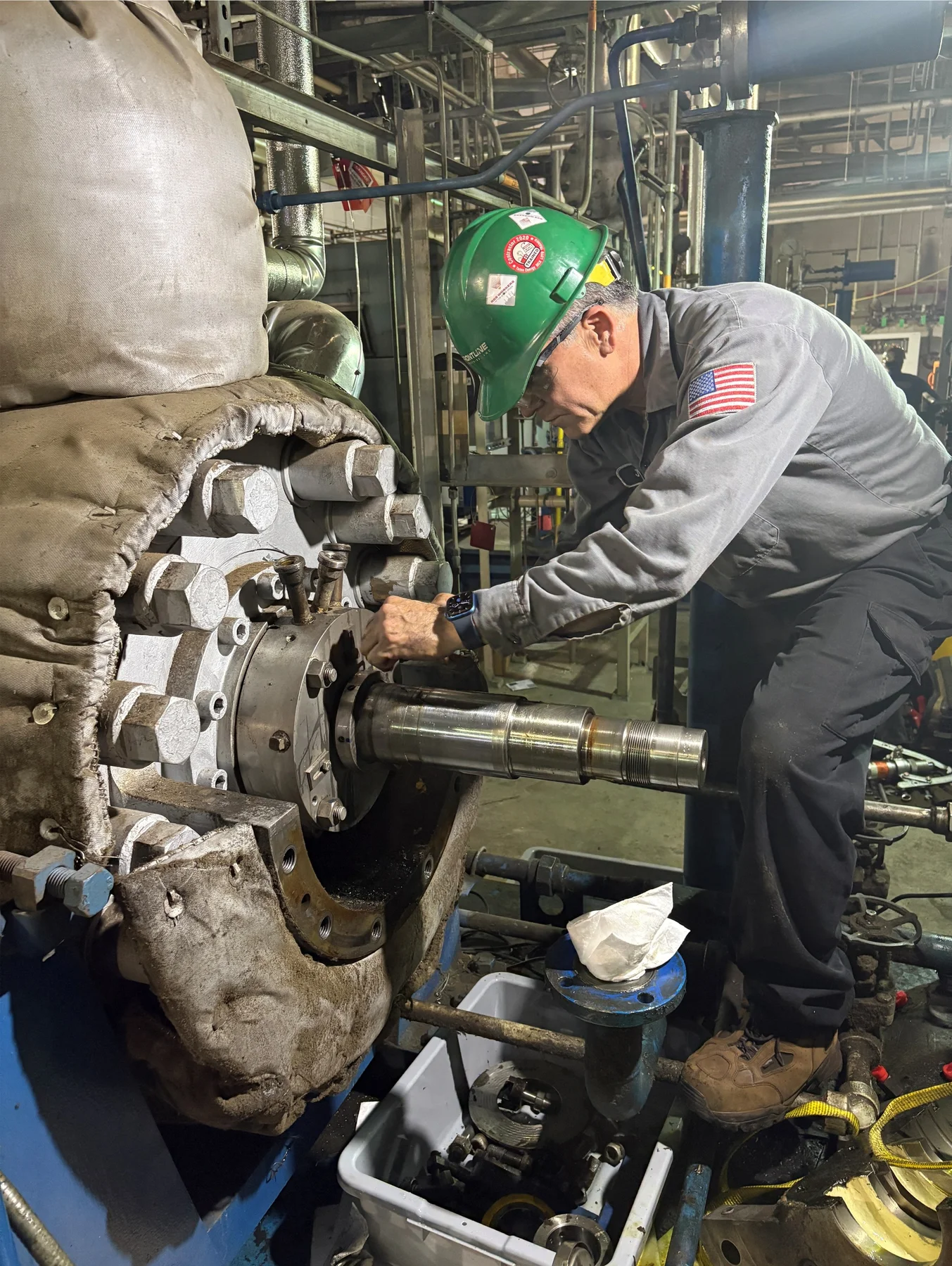Technician working on installed rotating equipment