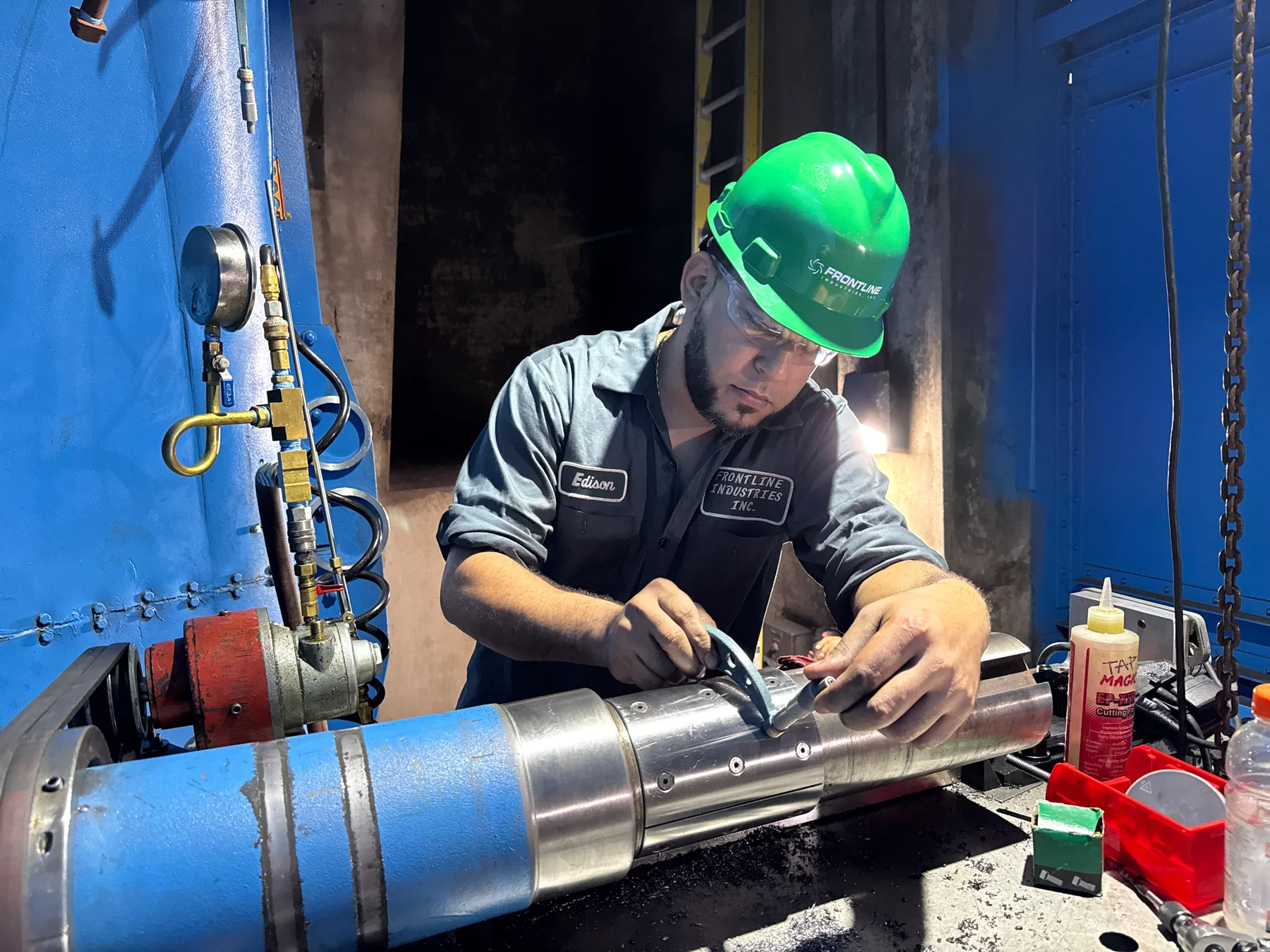 Technician machining a shaft on installed equipment